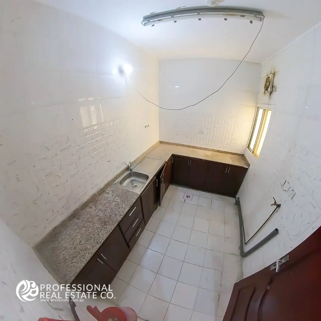 Unfurnished kitchen in 2 BHK apartment for rent in Bin Omran, Doha – Spacious and ready for your personal touches