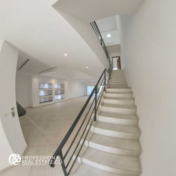 Elegant stairs leading to the upper floor in a semi-furnished 3 BHK compound villa in West Bay Lagoon – Designed for family comfort and style.