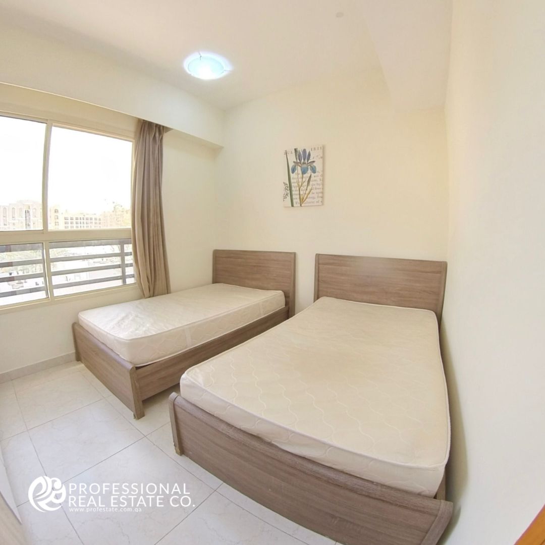 Spacious and stylish bedroom in a fully furnished 2 BHK apartment in Bin Mahmoud with high-quality furniture.