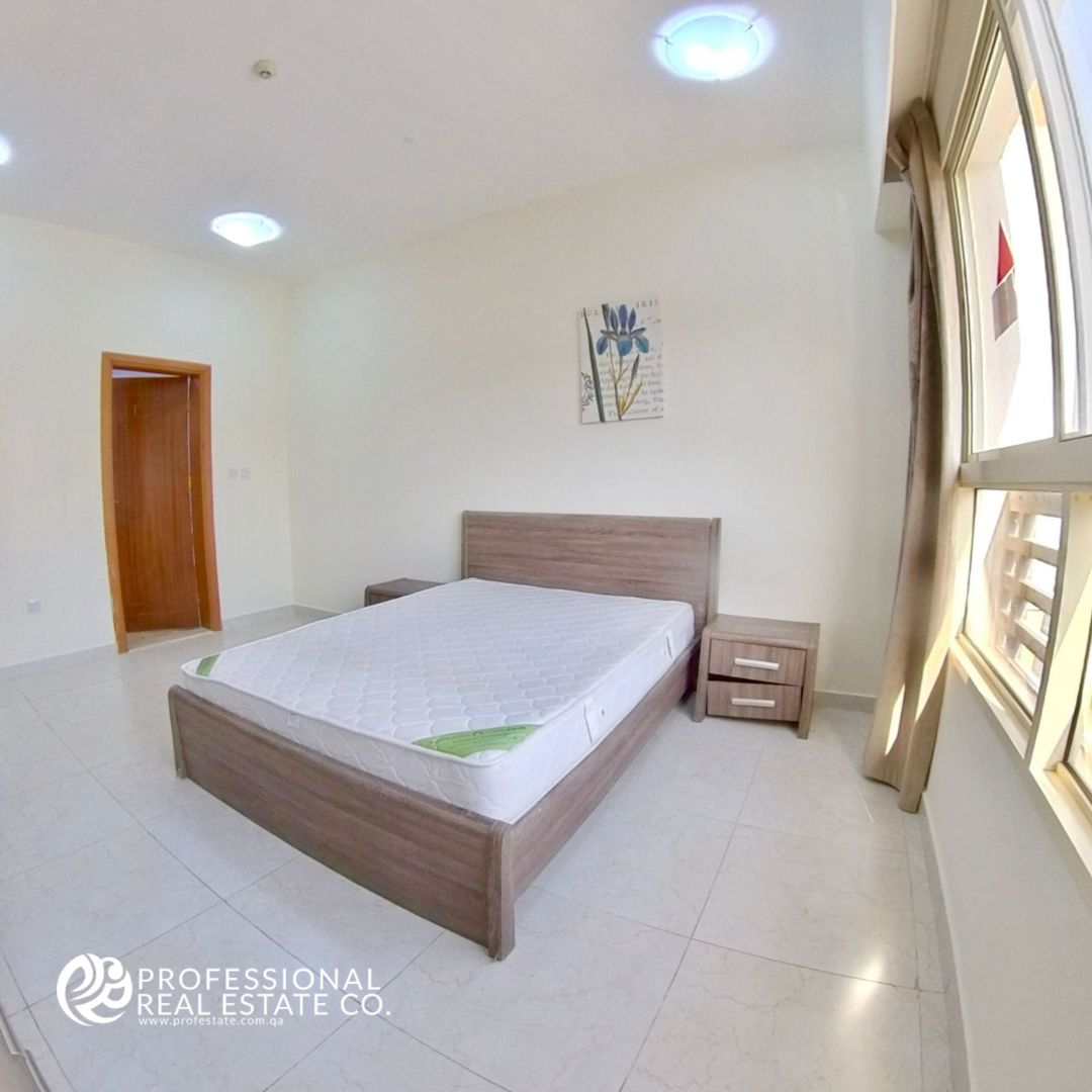 Spacious first bedroom in a fully furnished 2 BHK apartment in Bin Mahmoud, featuring high-quality furniture and elegant decor.