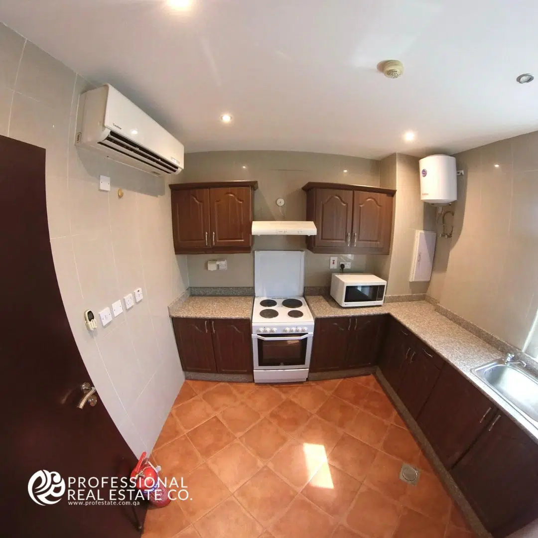 Fully equipped kitchen in 2 BHK apartment in Najma with modern appliances, spacious countertops, and sleek cabinetry.