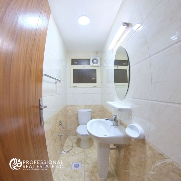 Elegant powder room in a fully furnished 2 BHK apartment in Bin Mahmoud, featuring modern fixtures and stylish decor.