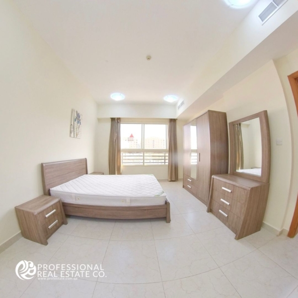 Spacious second bedroom in a fully furnished 2 BHK apartment in Bin Mahmoud, featuring high-quality furniture.