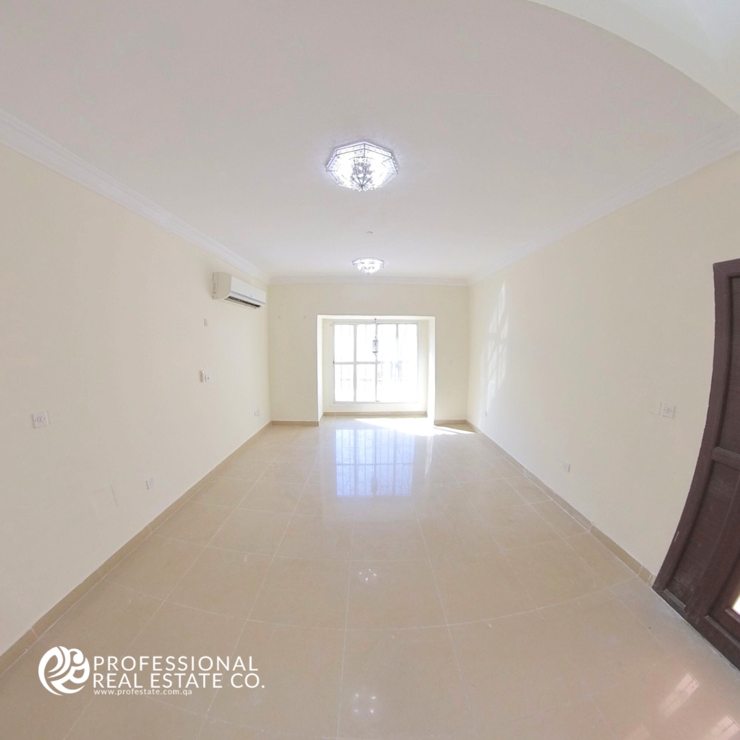 Spacious second bedroom in an unfurnished 5 BHK standalone villa in Al Waab, perfect for family living.