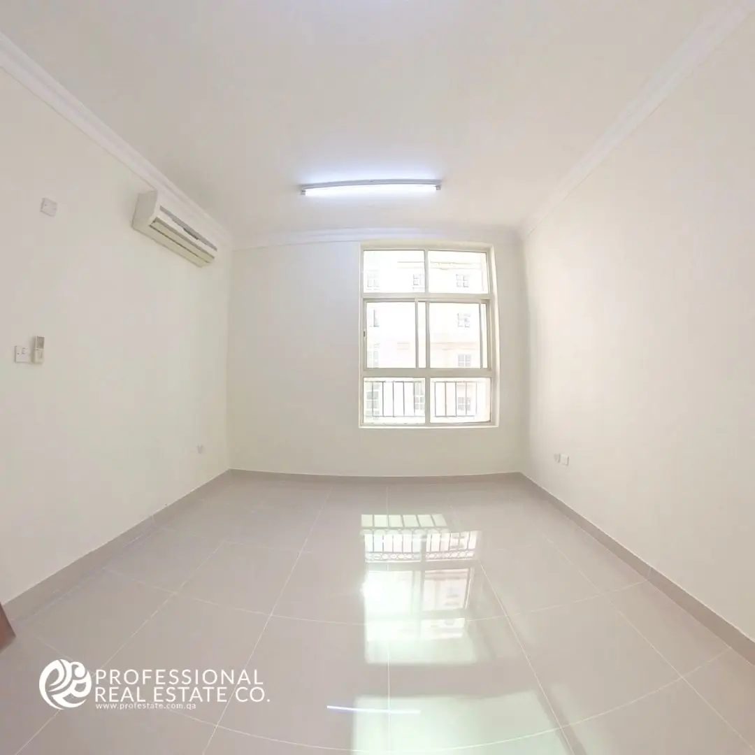 Spacious second bedroom in an unfurnished 2 BHK apartment in Doha Jadeed, near New Doha Complex.