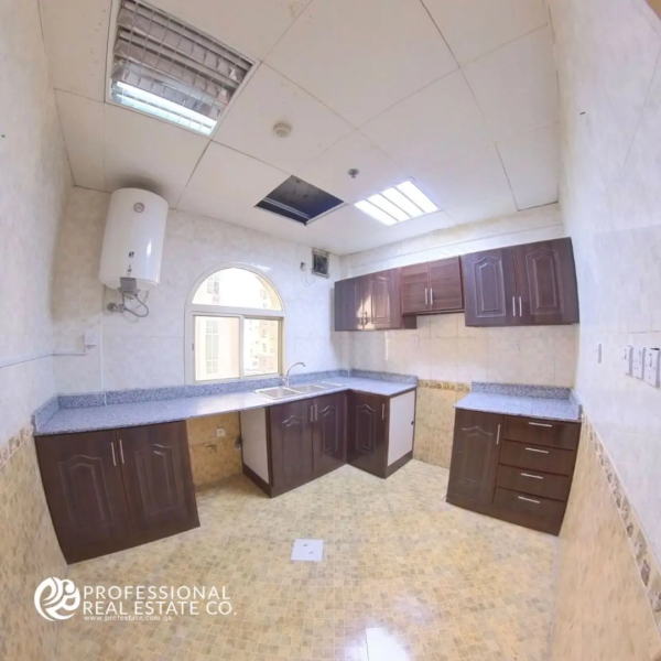 Modern kitchen in an unfurnished 2 BHK apartment in Doha Jadeed, near New Doha Complex.