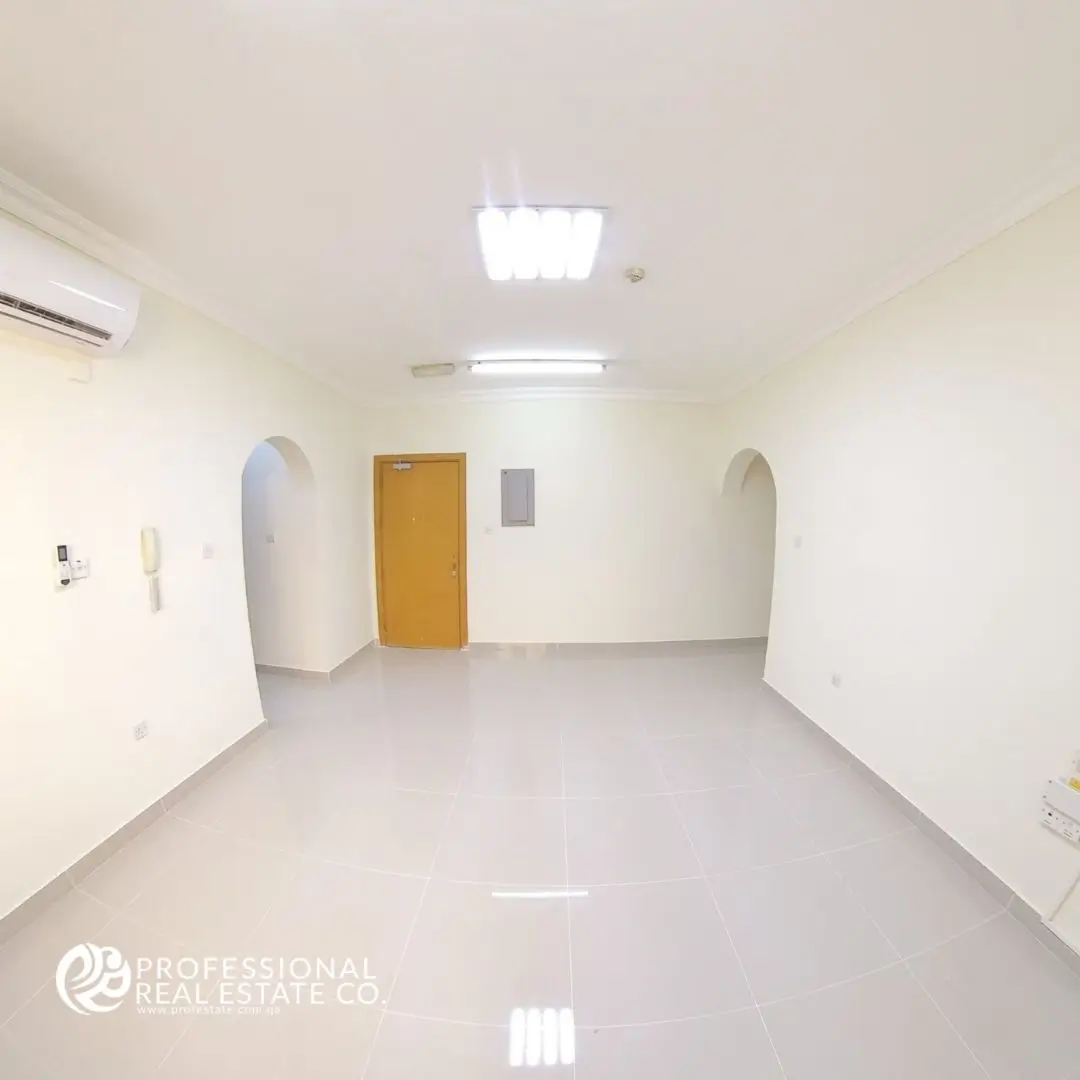 Spacious living area in an unfurnished 2 BHK apartment in Doha Jadeed, near New Doha Complex.