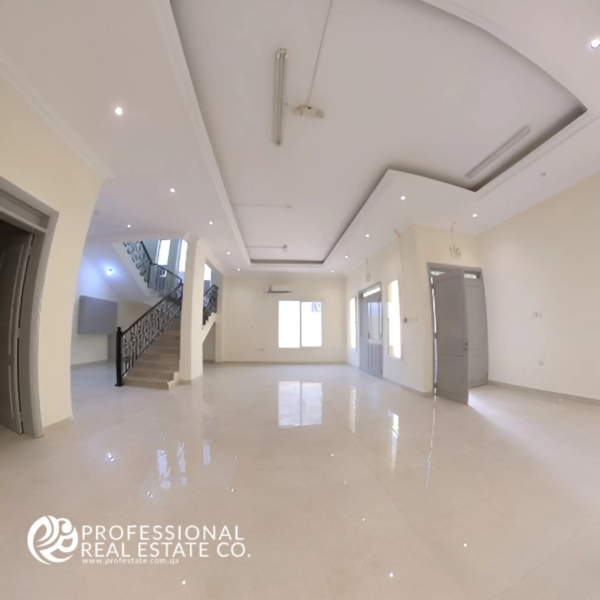 Alternative view of the living room facing the staircase in Unfurnished 6 BHK Standalone Villa in Umm Lekhba – Spacious, open layout with modern design.