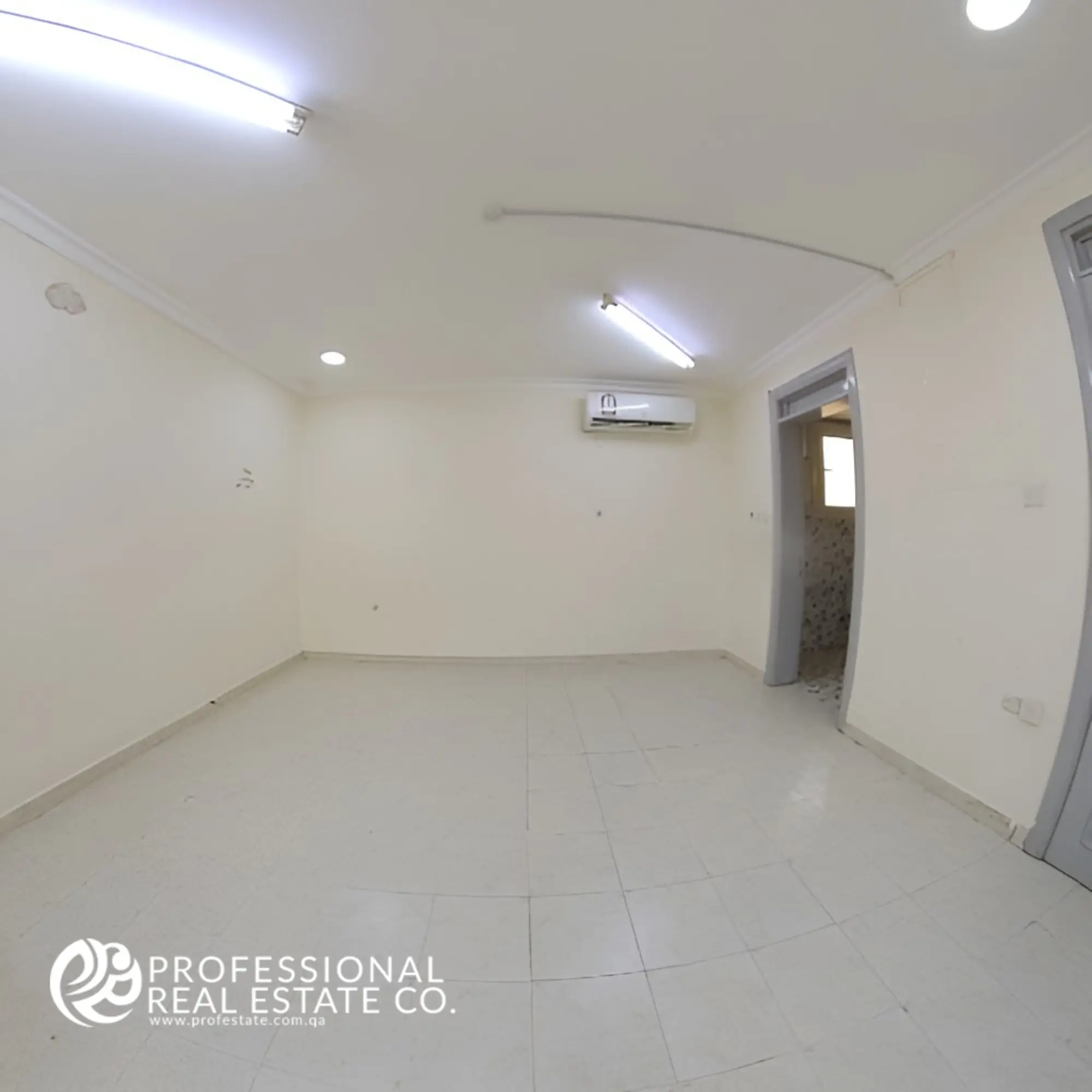 Spacious third bedroom in an unfurnished 6 BHK standalone villa for rent in Umm Lekhba, offering ample space and customization potential.