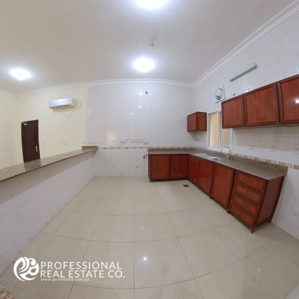 Spacious open kitchen in unfurnished 4 BHK apartment for rent in Al Naser, showcasing modern design and ample space for customization.