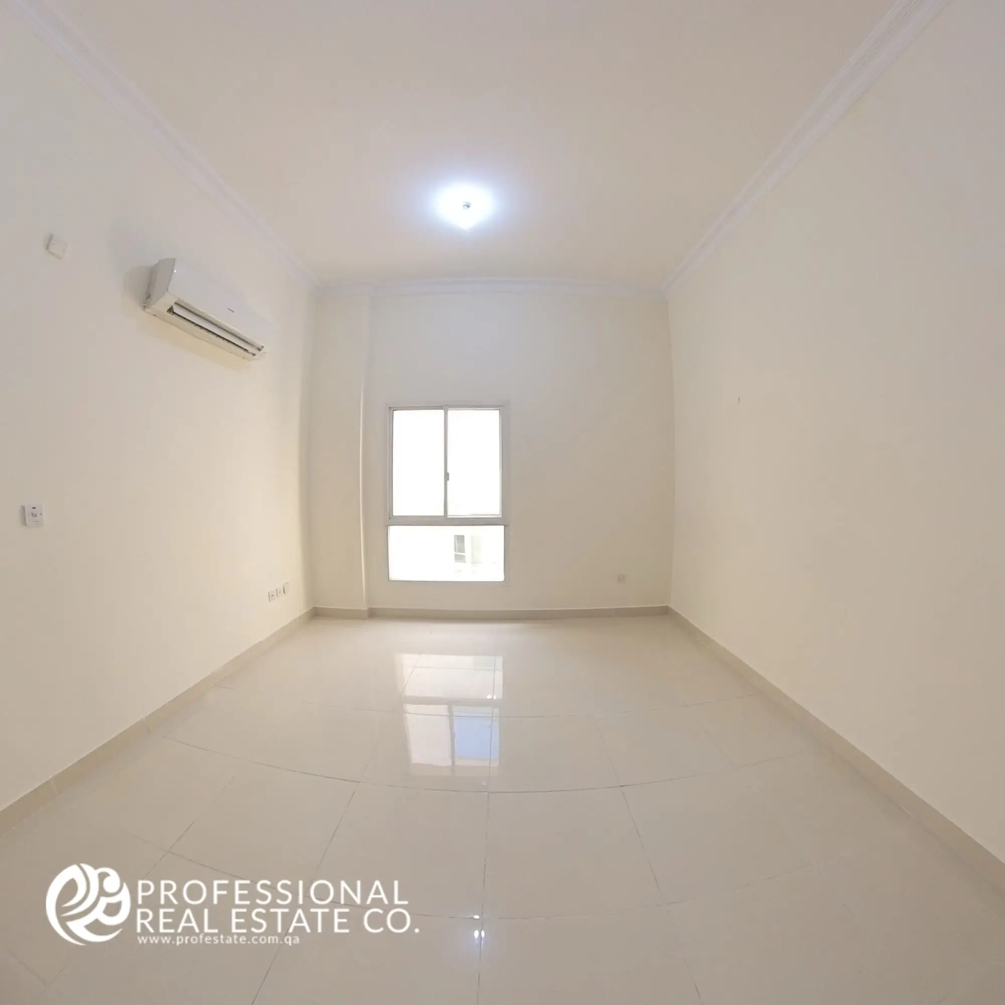 Cozy second bedroom in an unfurnished 4 BHK apartment for rent in Al Naser, offering a versatile space for personalization and design.