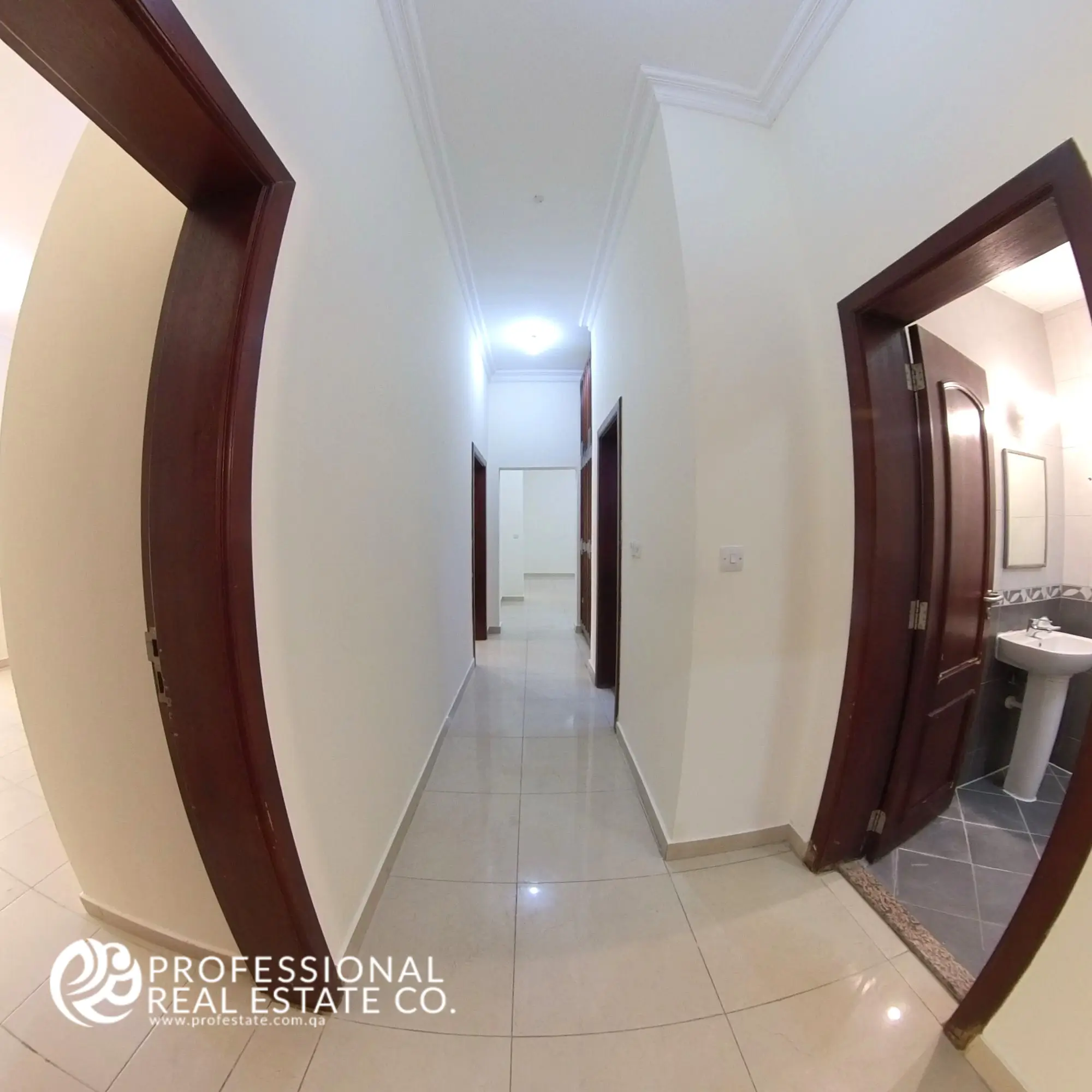 Bright and spacious hallway in an unfurnished 4 BHK apartment for rent in Al Naser, providing a seamless flow between rooms and endless customization potential.