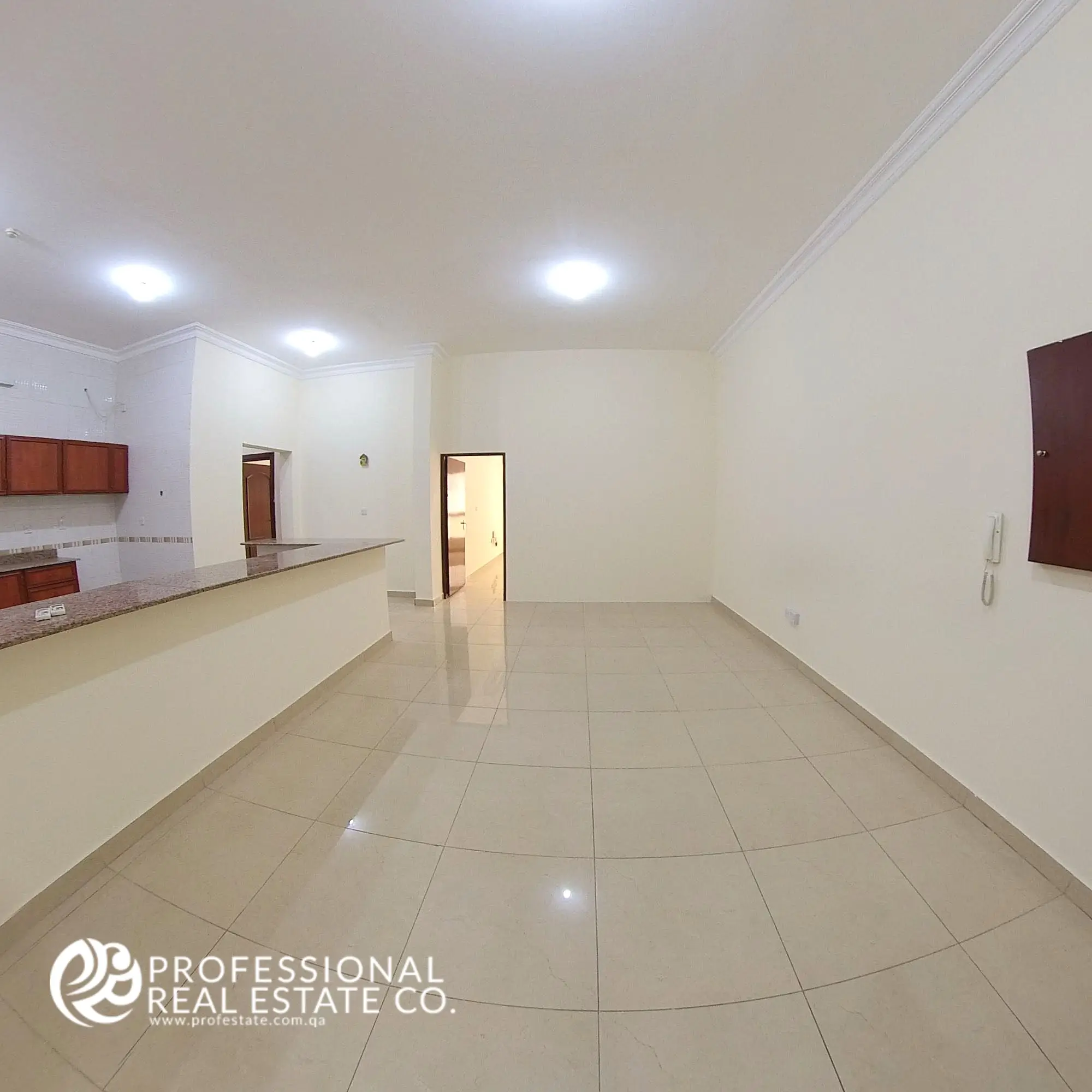 Spacious living room in an unfurnished 4 BHK apartment for rent in Al Naser, offering a bright, open layout with plenty of potential for customization.