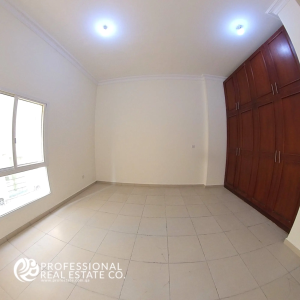 Spacious master bedroom in an unfurnished 4 BHK apartment for rent in Al Naser, offering plenty of natural light and customization potential.