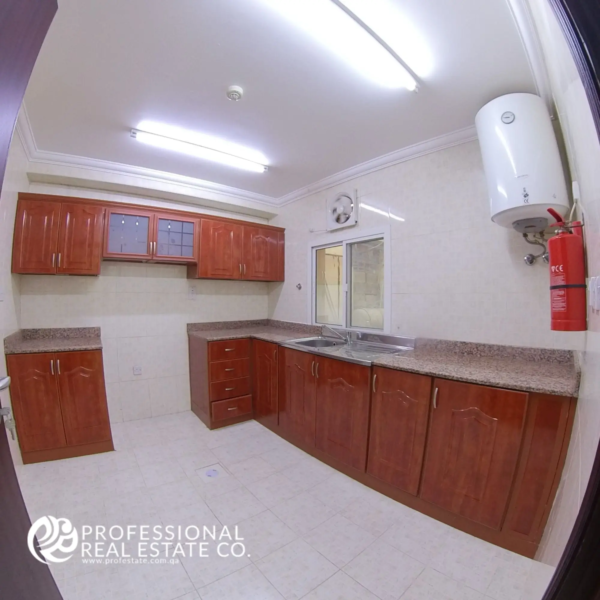 Alternative view of the kitchen in an unfurnished 2 BHK apartment in Al Gharrafa, offering a functional space ready for your design.