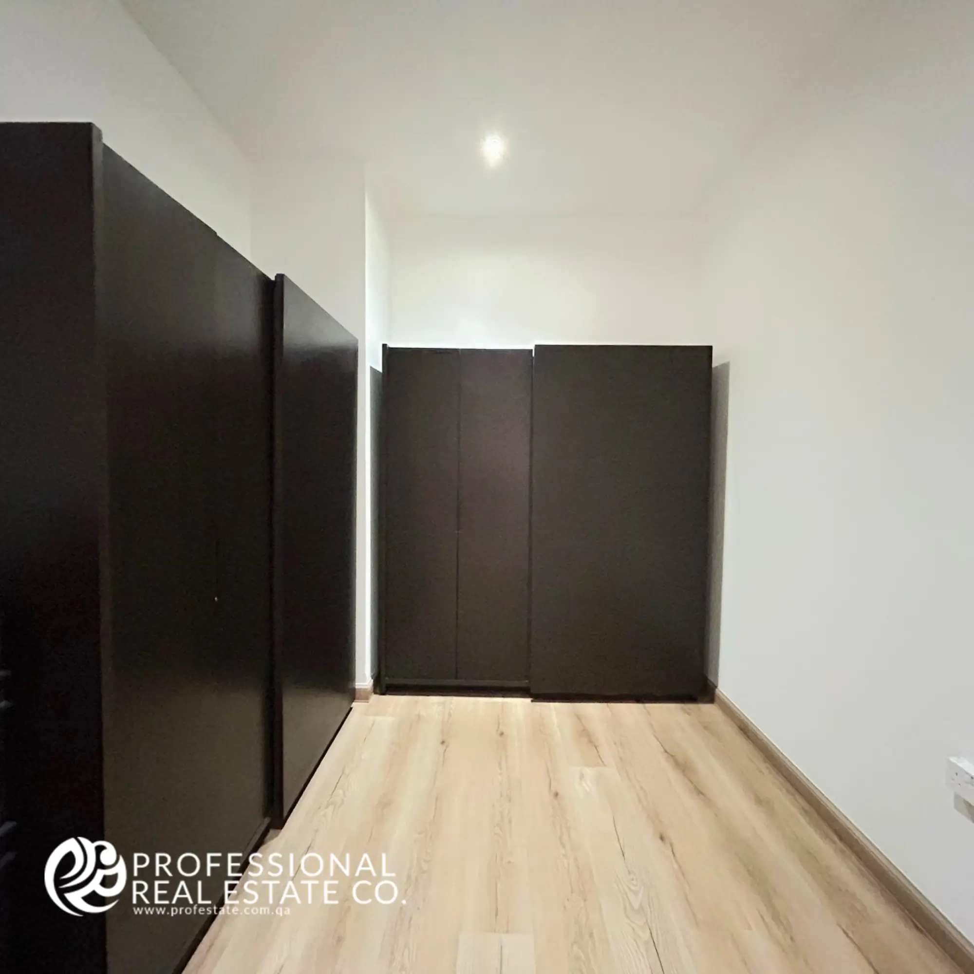 Spacious and well-designed closet in a fully furnished 5 BHK standalone villa in Umm Lekhba, featuring ample storage space, sleek shelving, and modern design for ultimate organization.