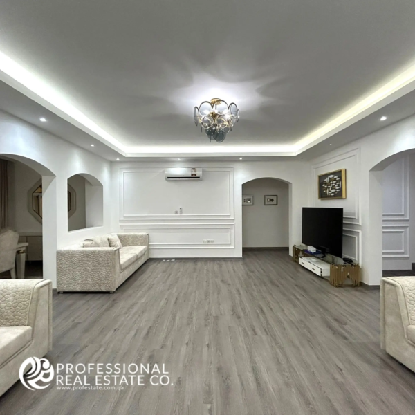 Spacious second living room in a fully furnished, luxurious 5 BHK standalone villa in Umm Lekhba, featuring stylish decor, modern furnishings, and an inviting atmosphere for relaxation and entertainment.