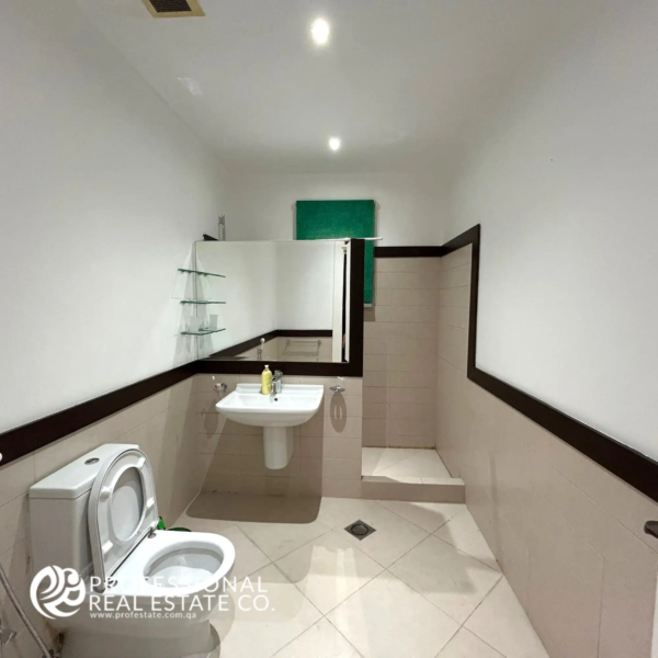 Spacious and elegantly designed Bathroom 1 in a fully furnished, luxurious 5 BHK standalone villa in Umm Lekhba, featuring modern fixtures and premium finishes.