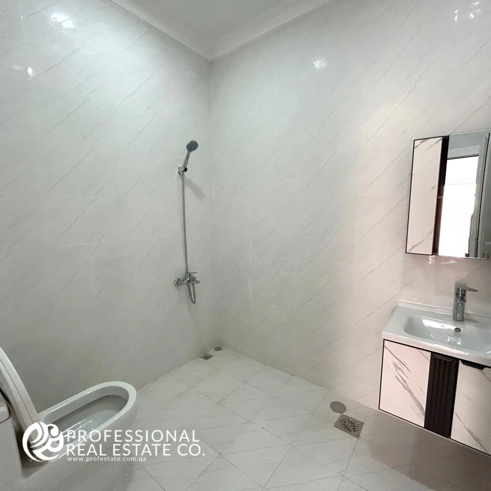 Maid’s bathroom in a fully furnished, spacious 5 BHK standalone villa in Umm Lekhba, featuring modern fixtures and a practical, well-designed layout.