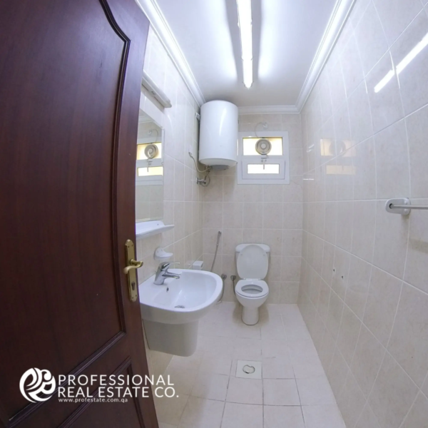 Toilet room in an unfurnished 2 BHK apartment in Al Gharrafa, offering a functional space ready for customization.