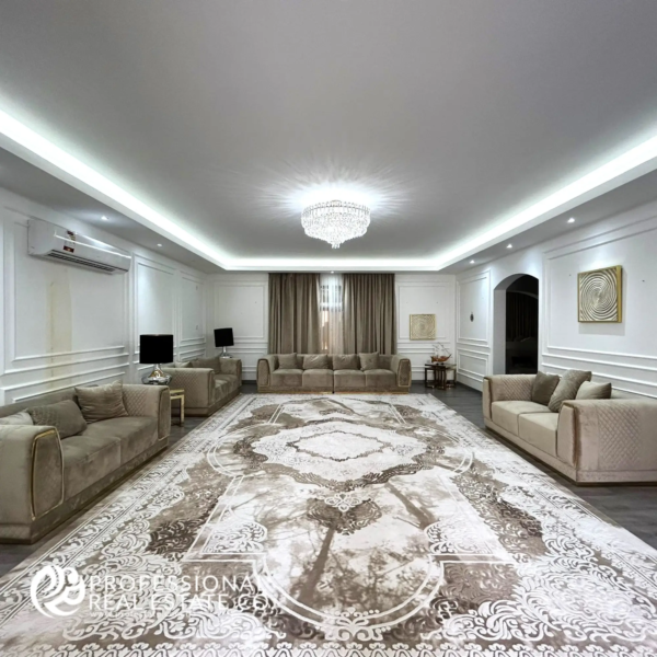 Spacious and elegantly designed main living room with high-end finishes, modern furnishings, and abundant natural light in a fully furnished 5 BHK villa in Umm Lekhba.