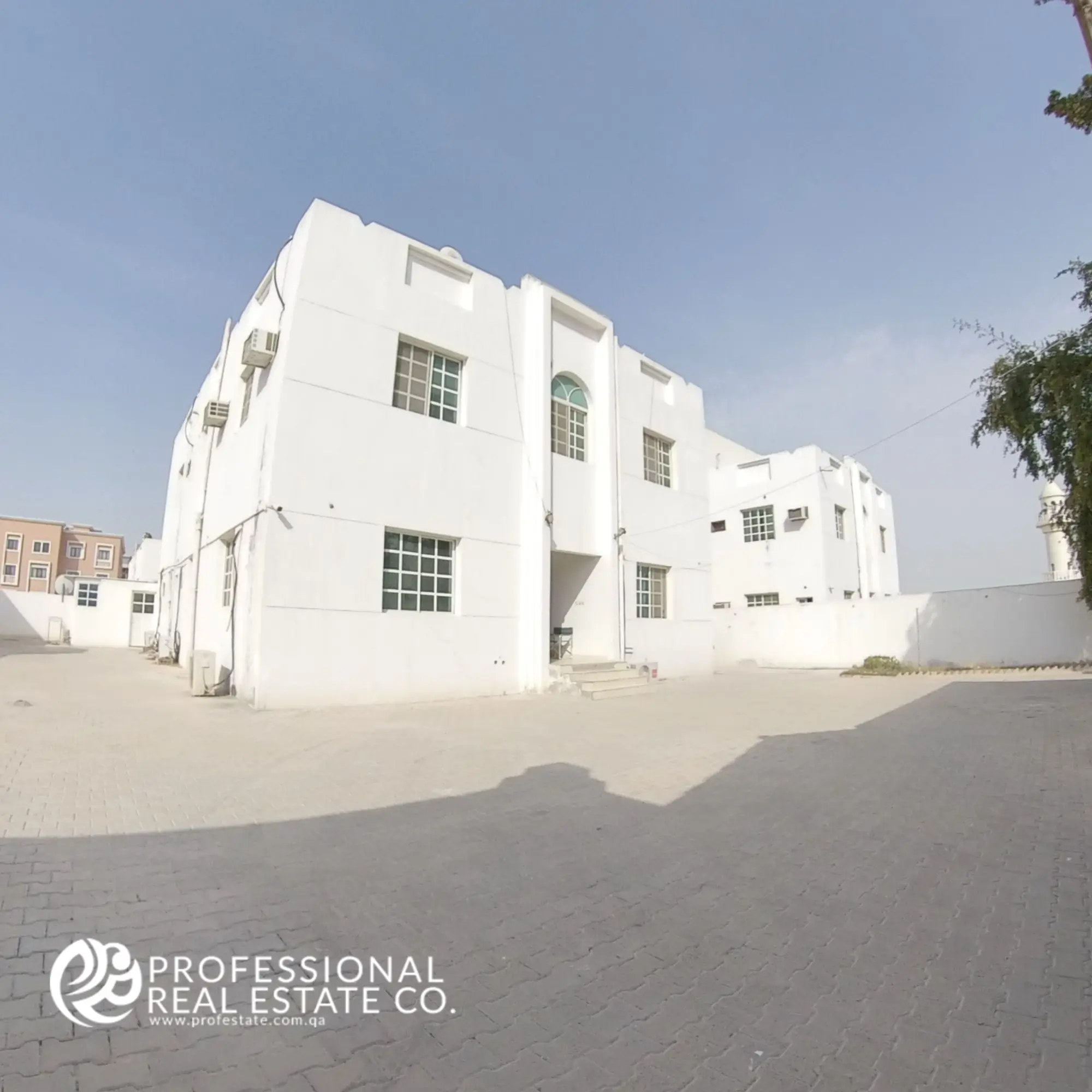 Another angle showcasing the modern and sleek exterior of a well-maintained building with an unfurnished 1 BHK apartment for rent in Umm Lekhba, highlighting its attractive architecture and prime location.