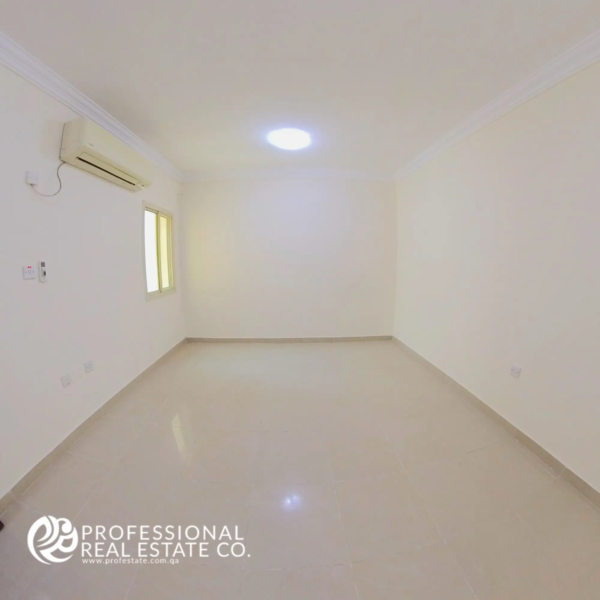 Bedroom 1 with tiled flooring and neutral walls in an unfurnished 2 BHK apartment in Al Sadd, Doha