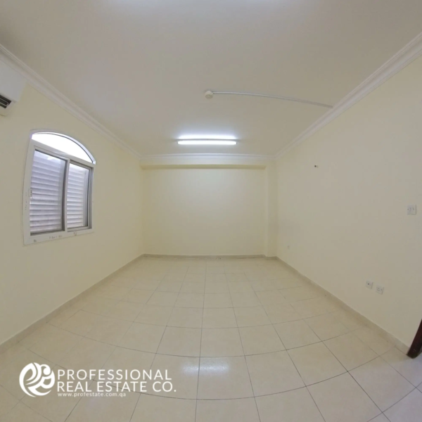 Bedroom 2 in an unfurnished 2 BHK apartment in Al Gharrafa, offering a spacious and adaptable space ready for your personal design.