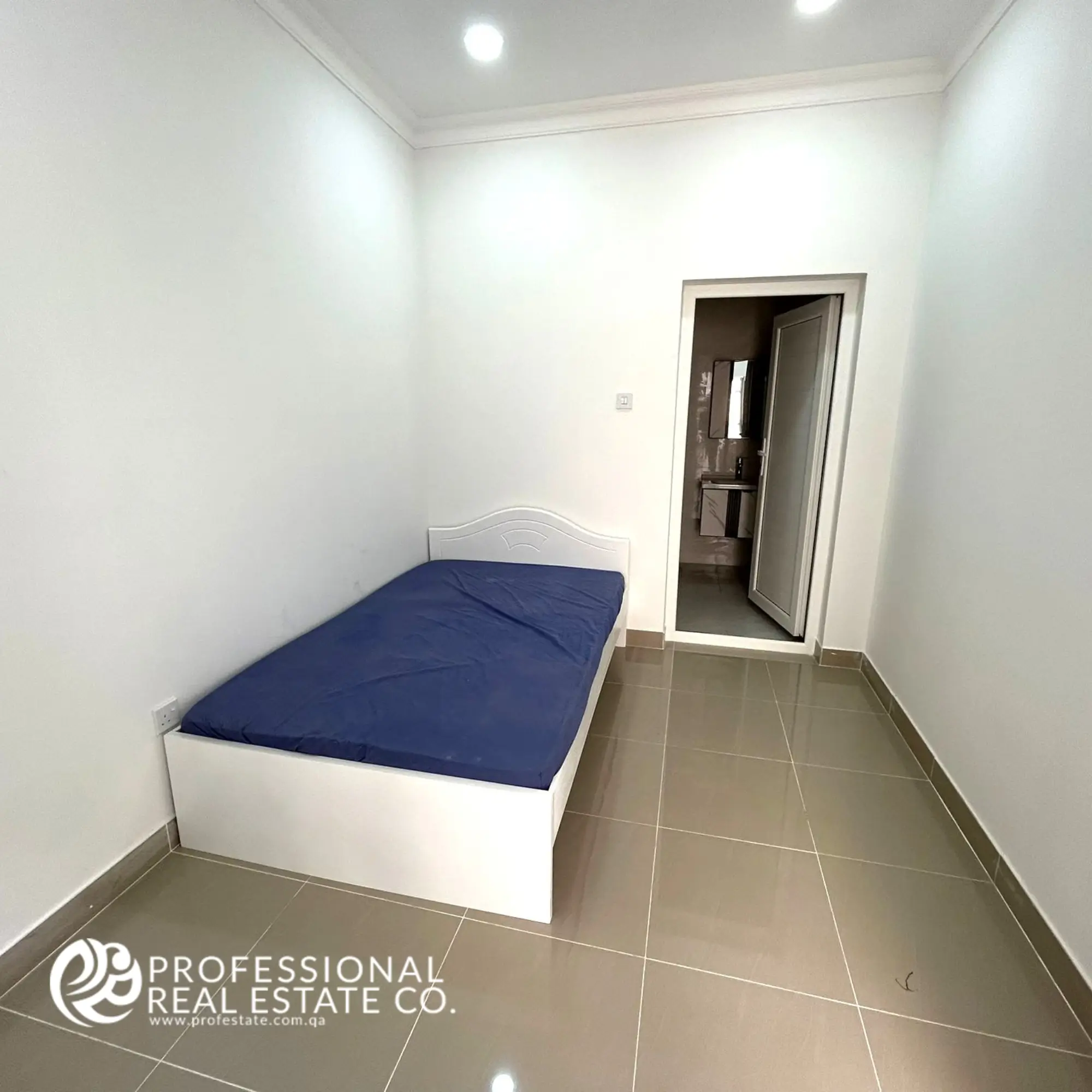 Spacious maid's room with private bathroom, offering comfort and privacy in a fully furnished 5 BHK villa in Umm Lekhba.