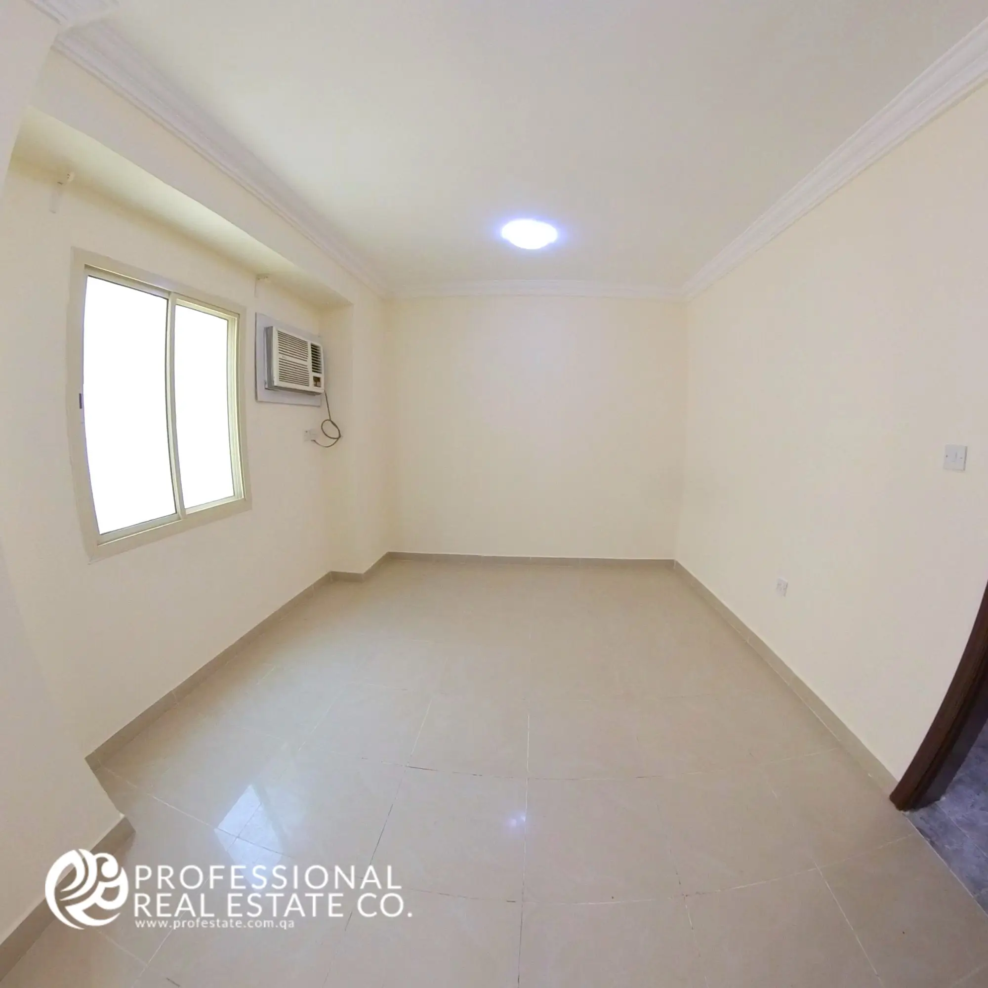 Bedroom 2 with tiled flooring and neutral walls in an unfurnished 2 BHK apartment in Al Sadd, Doha