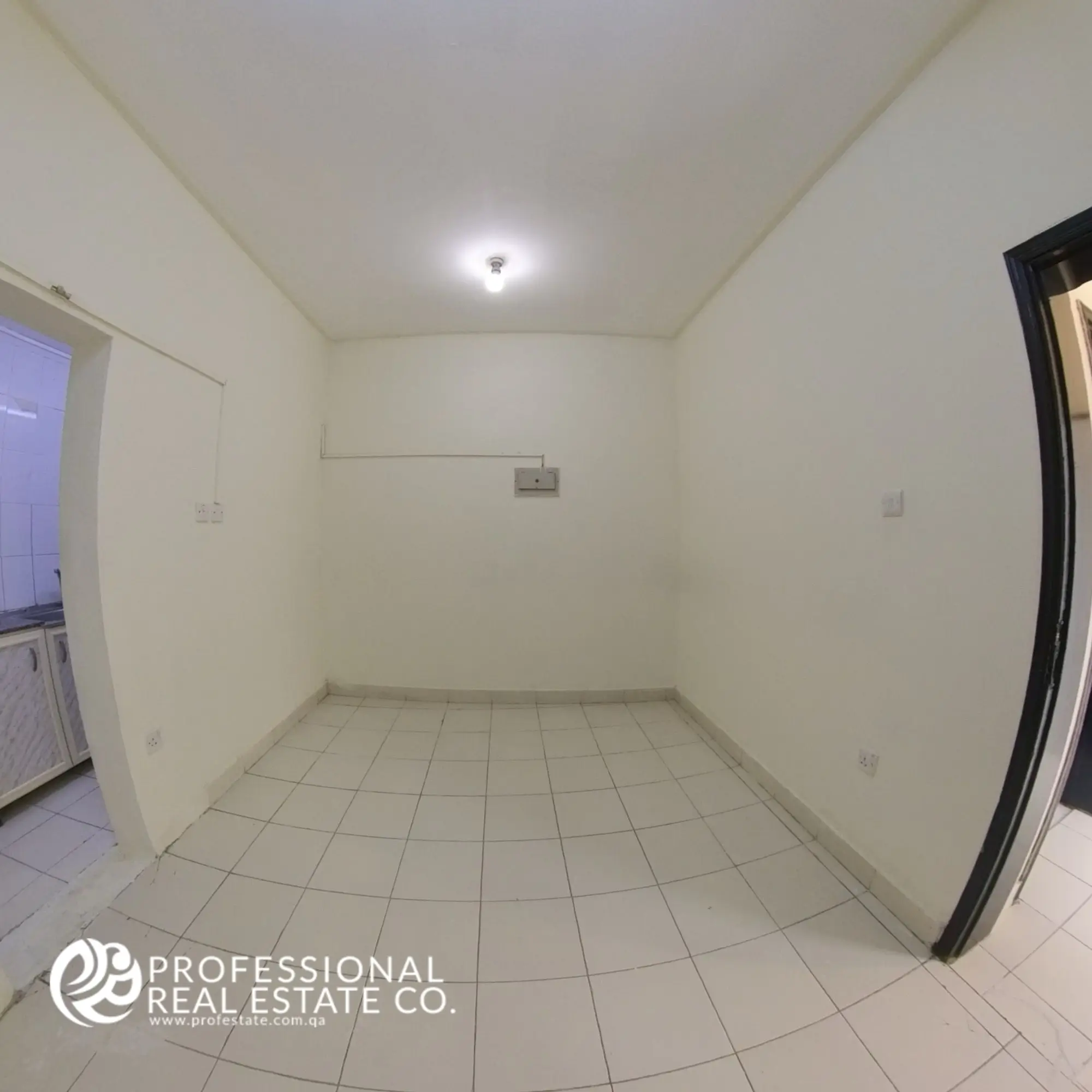 "Spacious living room in an unfurnished 1 BHK apartment for rent in Umm Lekhba, featuring an open layout with ample natural light, offering endless possibilities for customization.