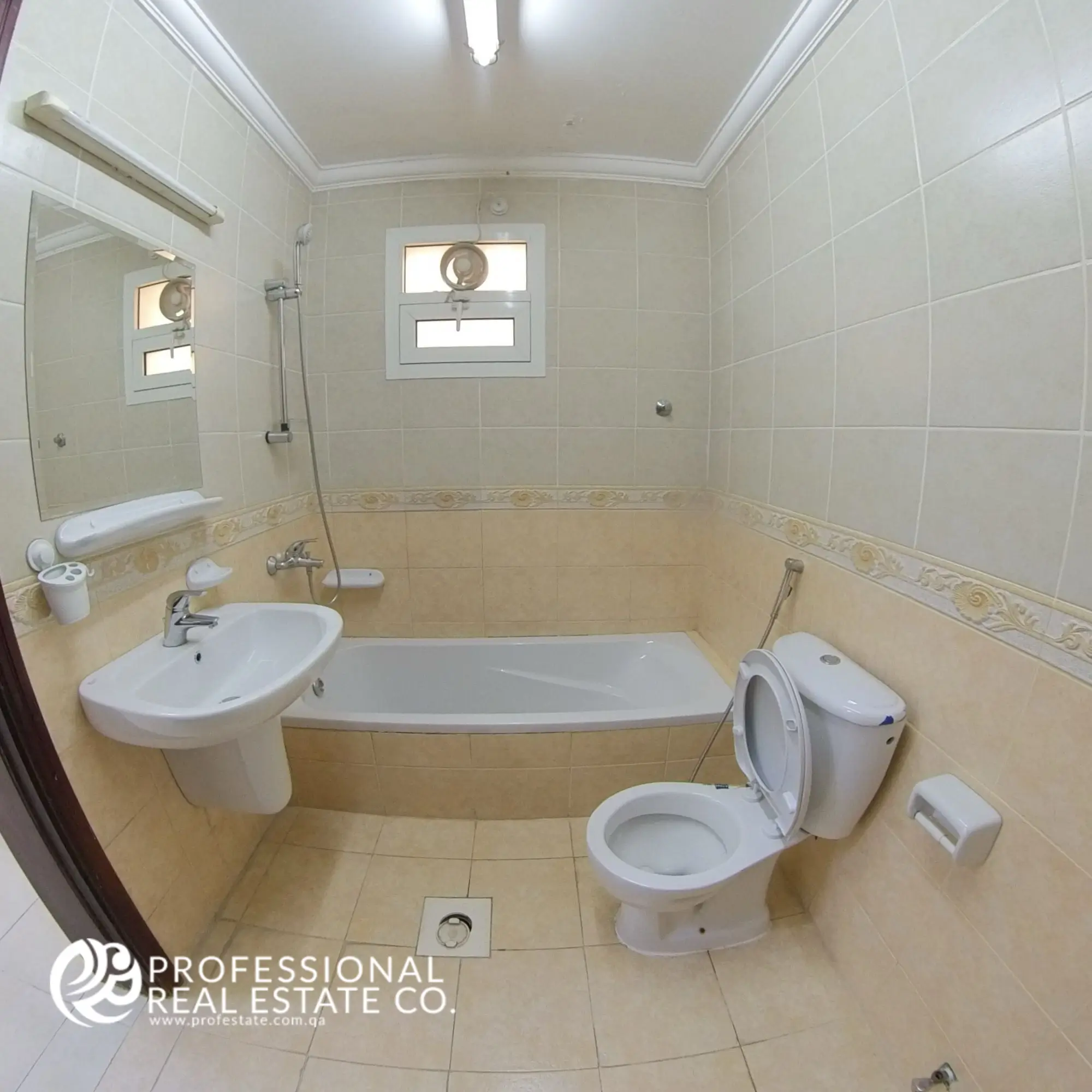 Bathroom with tub in an unfurnished 2 BHK apartment in Al Gharrafa, offering a functional space ready for your personal touch.