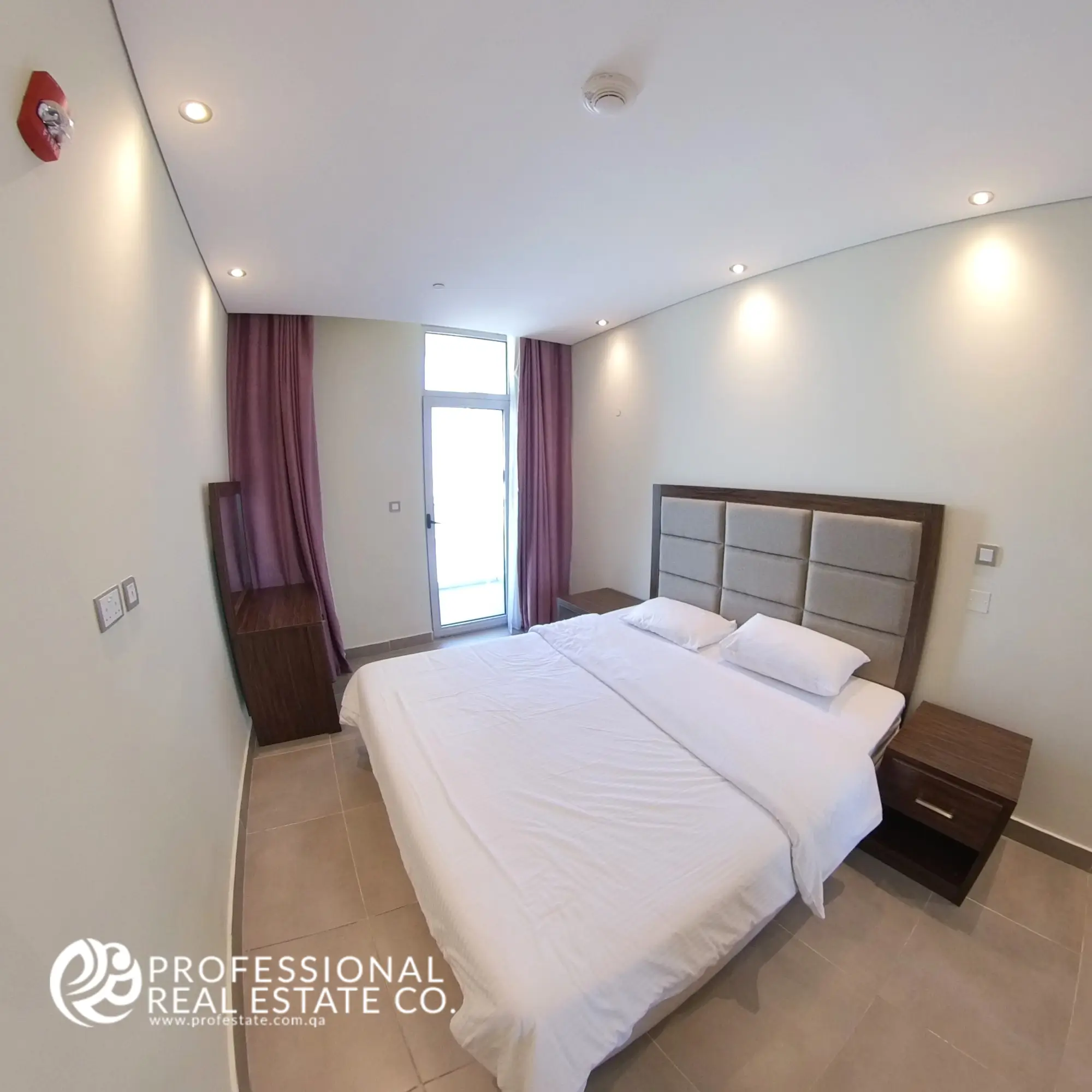 Spacious and well-furnished bedroom in a fully furnished 1-bedroom apartment in Al Sadd, Doha, featuring modern décor, ample natural light, and a comfortable space for rest and relaxation.