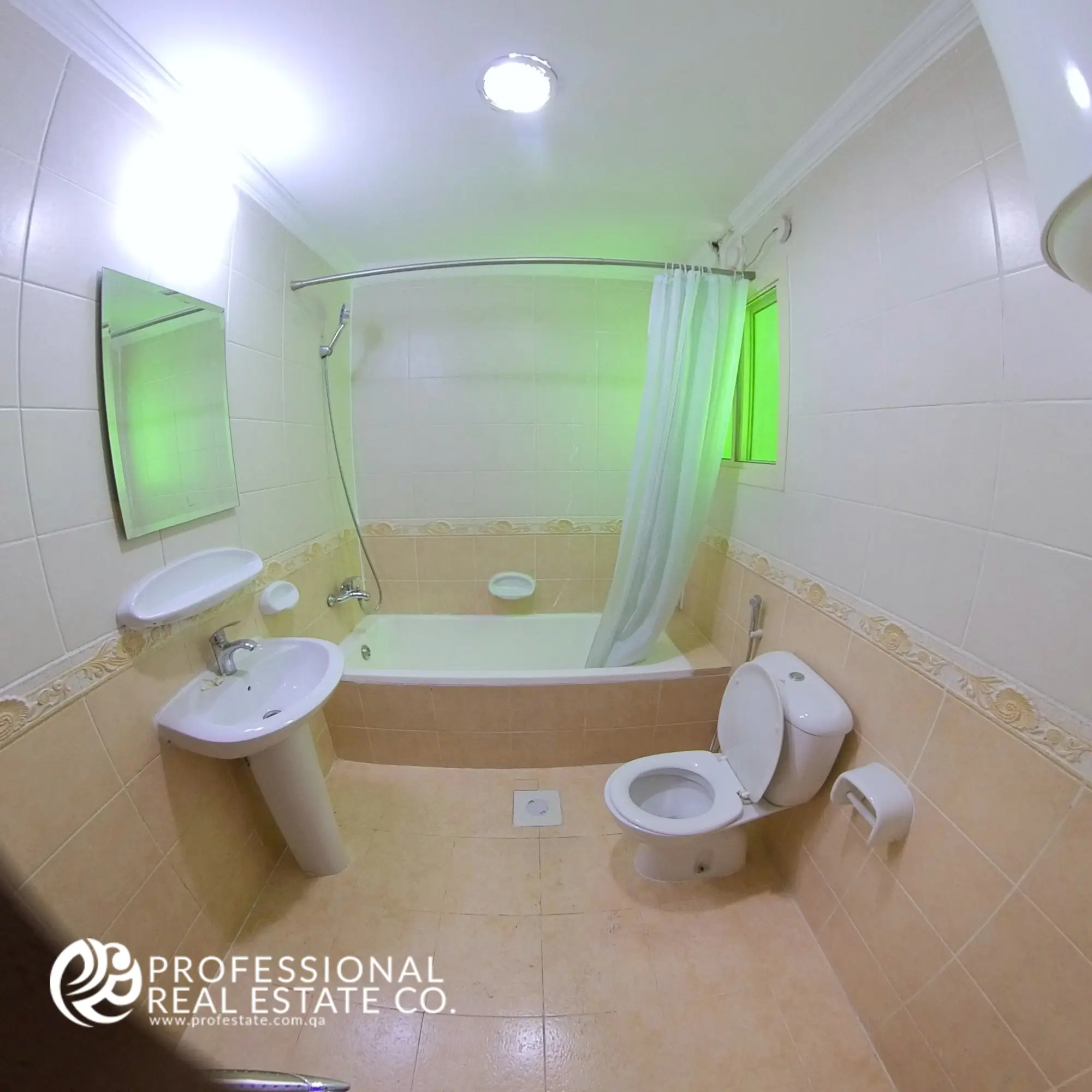 Toilet room with bathtub and shower in an unfurnished 2 BHK apartment in Al Sadd, Doha
