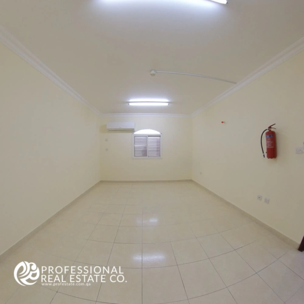 Bedroom 1 in an unfurnished 2 BHK apartment in Al Gharrafa, offering a spacious and versatile space ready for customization.