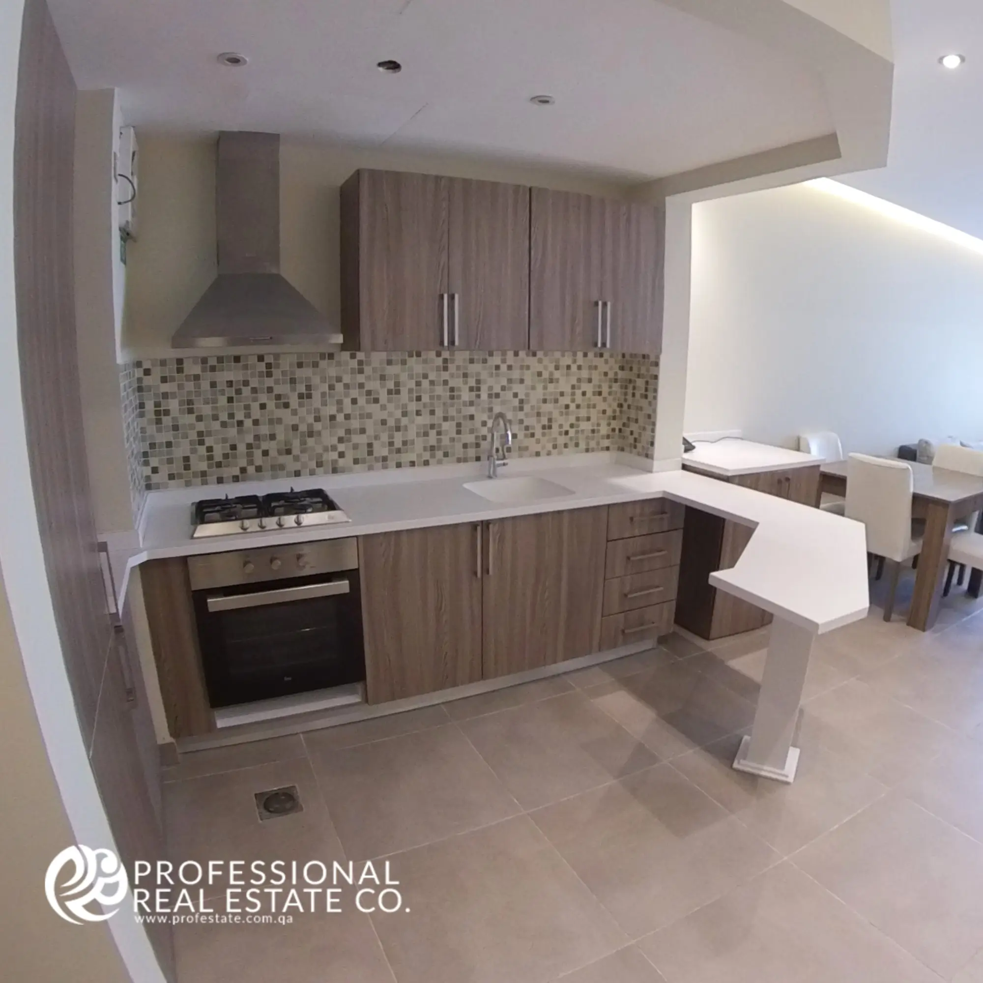 Open kitchen in a fully furnished 1-bedroom apartment in Al Sadd, Doha, featuring modern appliances, sleek countertops, and ample storage, designed for functionality and seamless living.