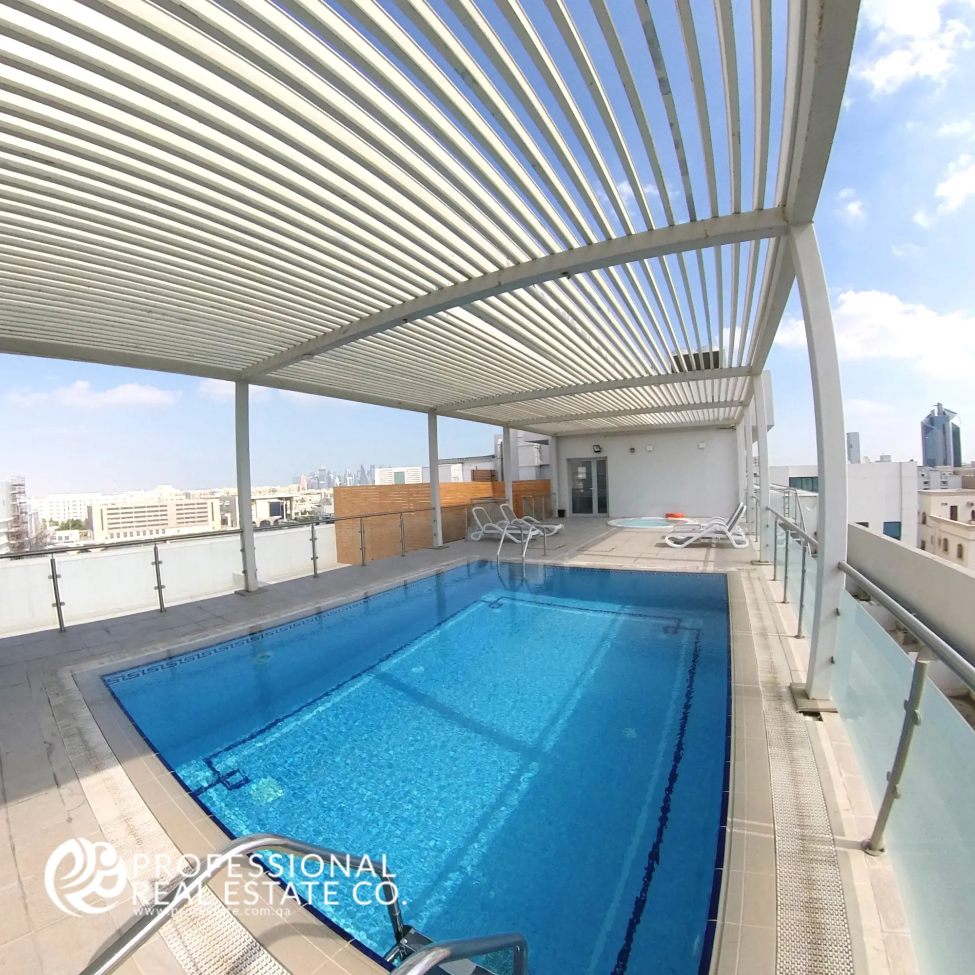 Sparkling swimming pool in the building of a fully furnished 1-bedroom apartment in Al Sadd, Doha, offering a relaxing retreat with modern amenities in a prime location, ideal for residents seeking comfort and leisure.