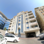 External view of the modern building featuring an unfurnished 2 BHK apartment in Najma, showcasing clean architecture and a prime location.