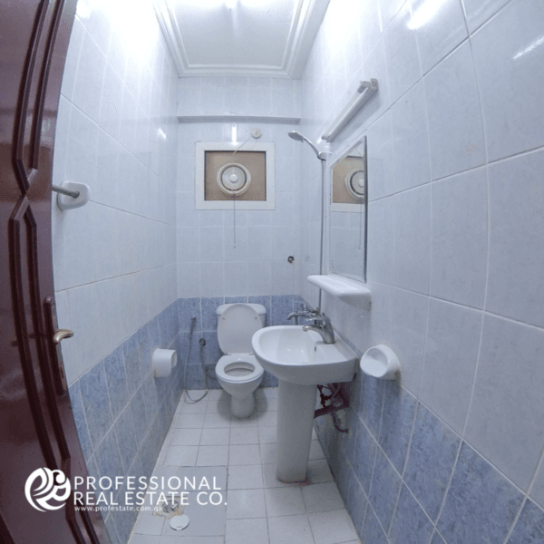 Cozy toilet room with a shower in an unfurnished 2 BHK apartment in Najma, offering a compact and functional space ready for customization.