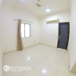 Bright and spacious bedroom in an unfurnished studio apartment for rent in Al Gharrafa, featuring a window and neutral walls for easy personalization.
