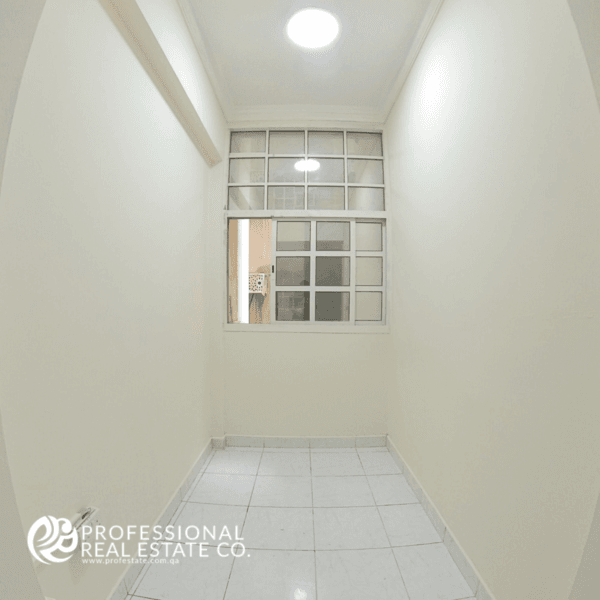 Window side of the spacious living room in an unfurnished 2 BHK apartment in Najma, featuring plenty of natural light and a bright, open atmosphere.