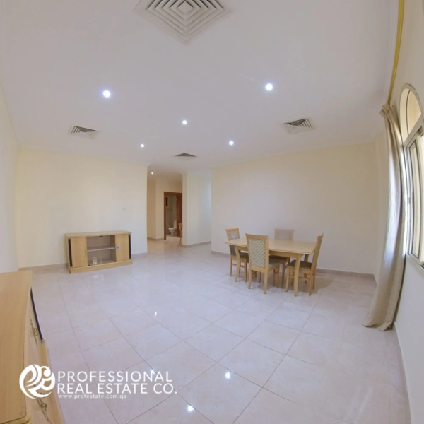 Alternative view of the living room featuring the dining area in a semi-furnished 2 BHK apartment in Muntazah, Doha