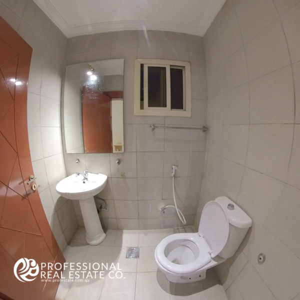 Modern, hygienic bathroom with Western toilet and premium fittings in a semi-furnished 2 BHK apartment for rent in Muntazah, Doha