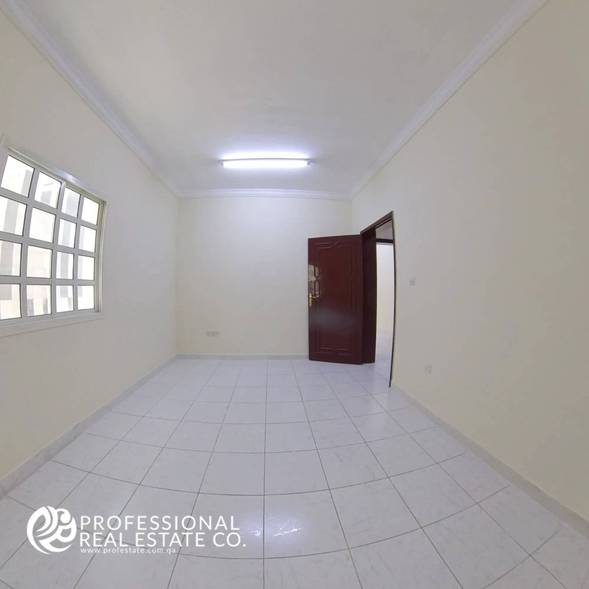 Alternative angle of Bedroom 2 with tiled floors and neutral walls in 2 BHK apartment in Najma, Doha