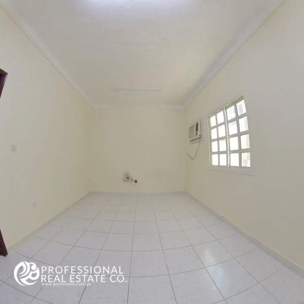 Secondary bedroom with tiled floor and window in unfurnished 2 BHK apartment in Najma, Doha