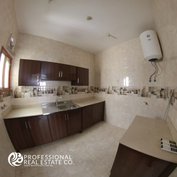 Alternative view of closed kitchen with cabinetry in an unfurnished 2 BHK apartment in Muntazah, Doha