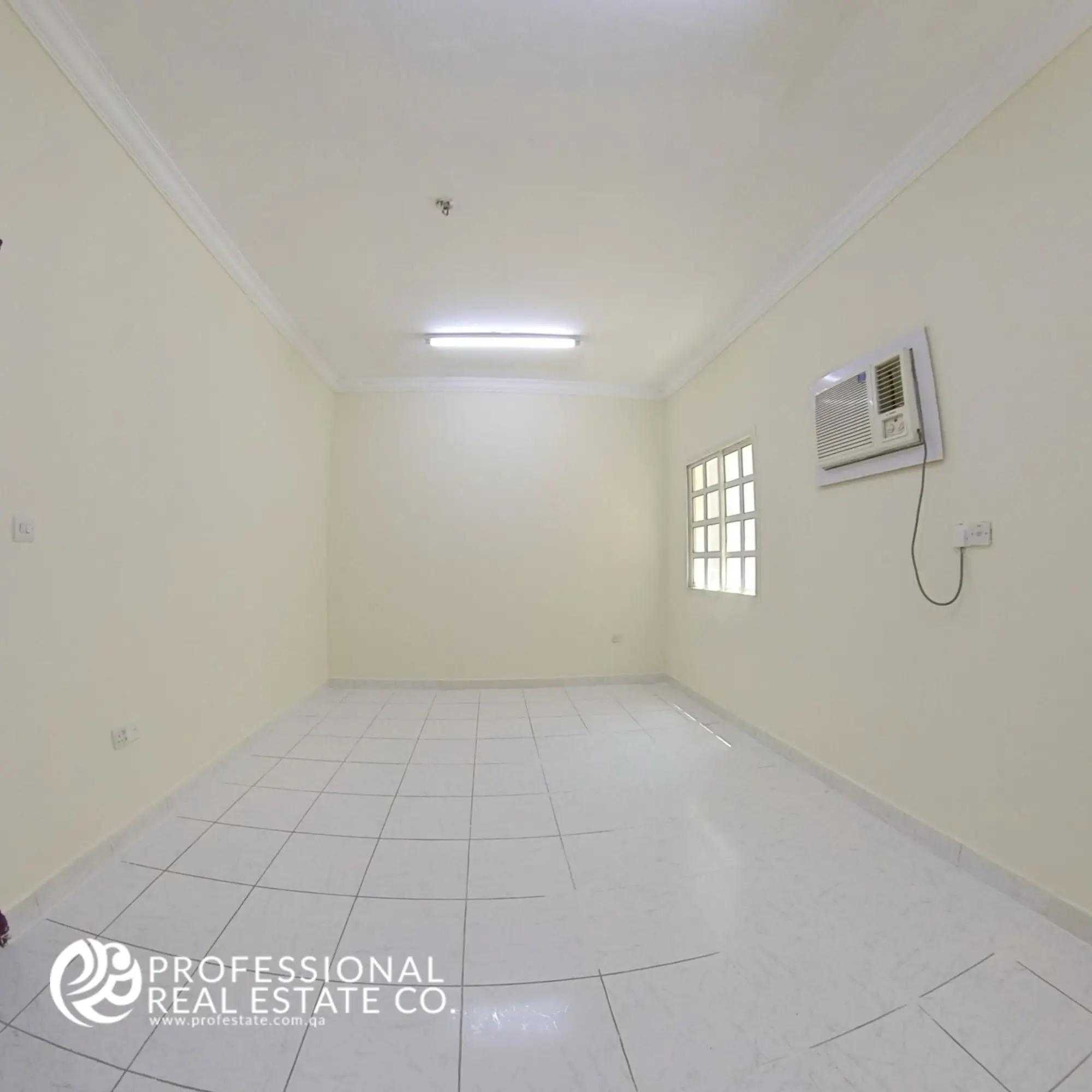 Standard bedroom with tiled flooring and window in 2 BHK unfurnished apartment in Najma, Doha