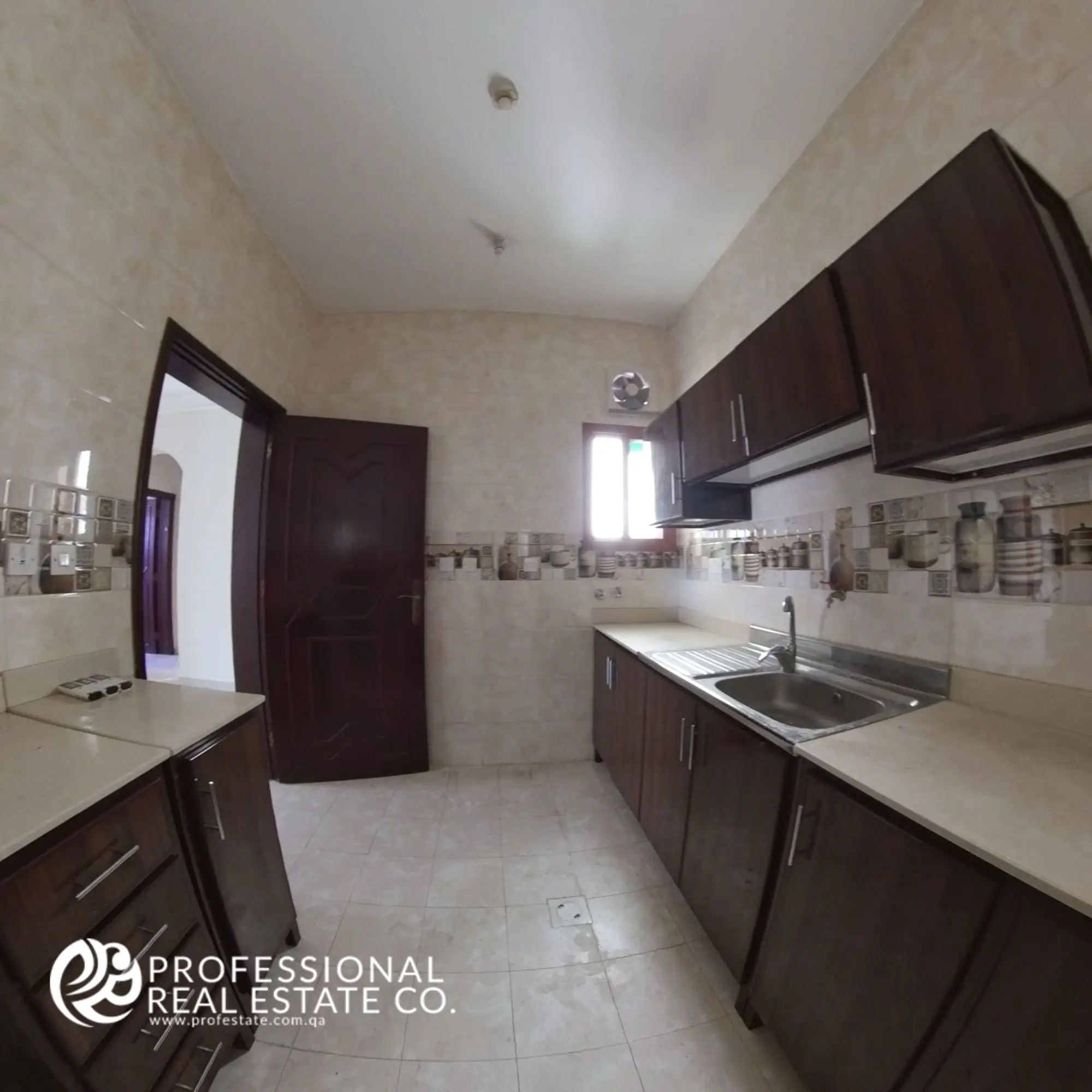 Closed kitchen with built-in storage in an unfurnished 2 BHK apartment in Muntazah, Doha