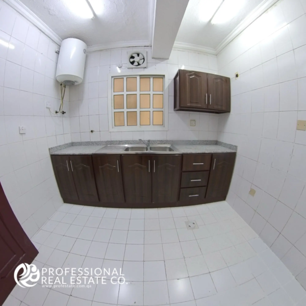 Closed kitchen with cabinets in unfurnished 2 BHK apartment for rent in Najma, Doha
