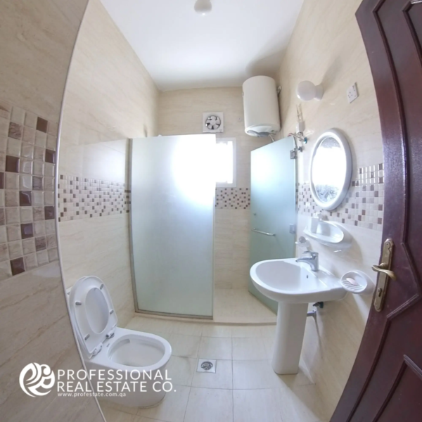 Bathroom with shower compartment and modern fixtures in an unfurnished 2 BHK apartment in Muntazah, Doha